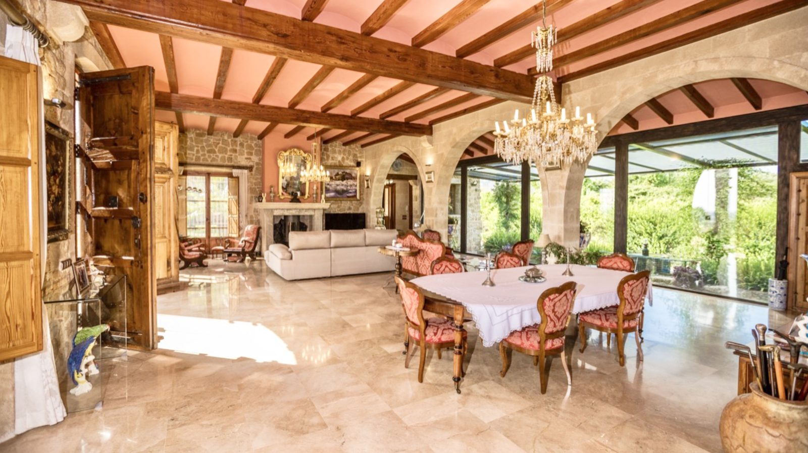 Elegant living and dining area with exposed beams and large windows in a 7-bedroom finca in Denia - The Estates