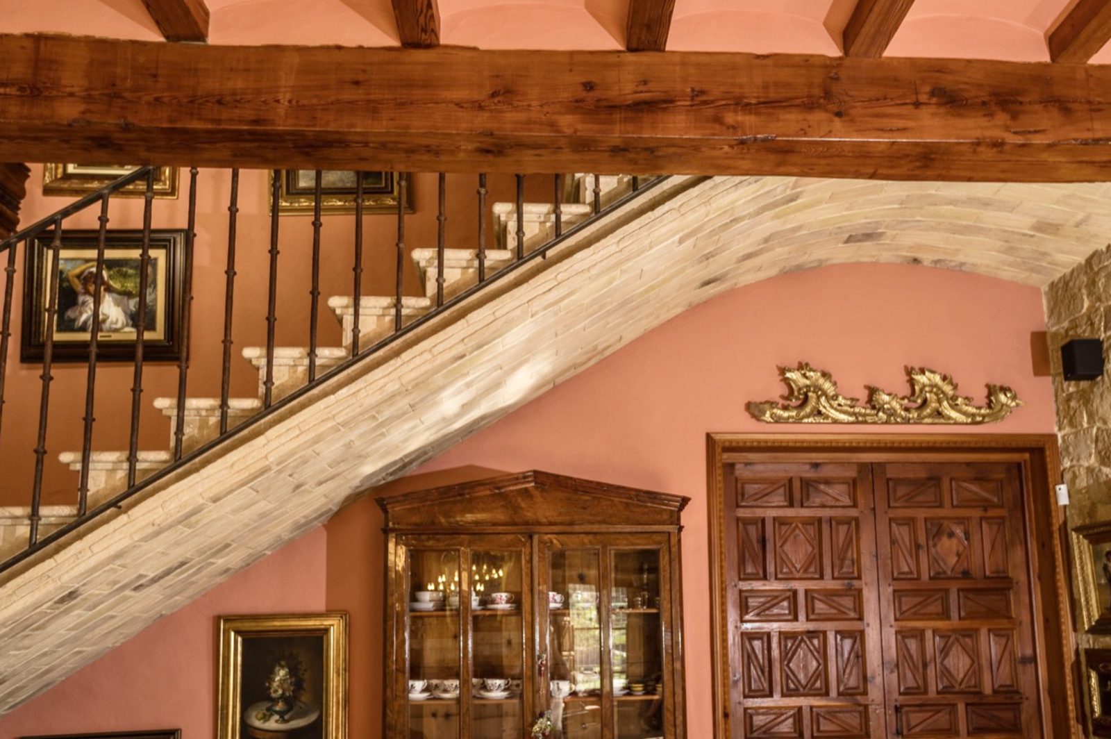 Elegant interior details, including a stone staircase and wooden beams, of a 7-bedroom finca in Denia - The Estates