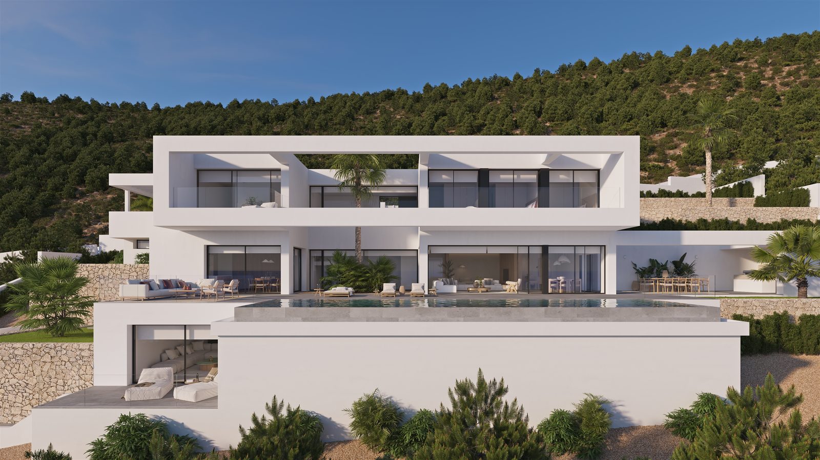 Modern white villa with infinity pool, terraces and landscaped gardens against a wooded hillside, of a 4-bedroom villa in Benissa - The Estates