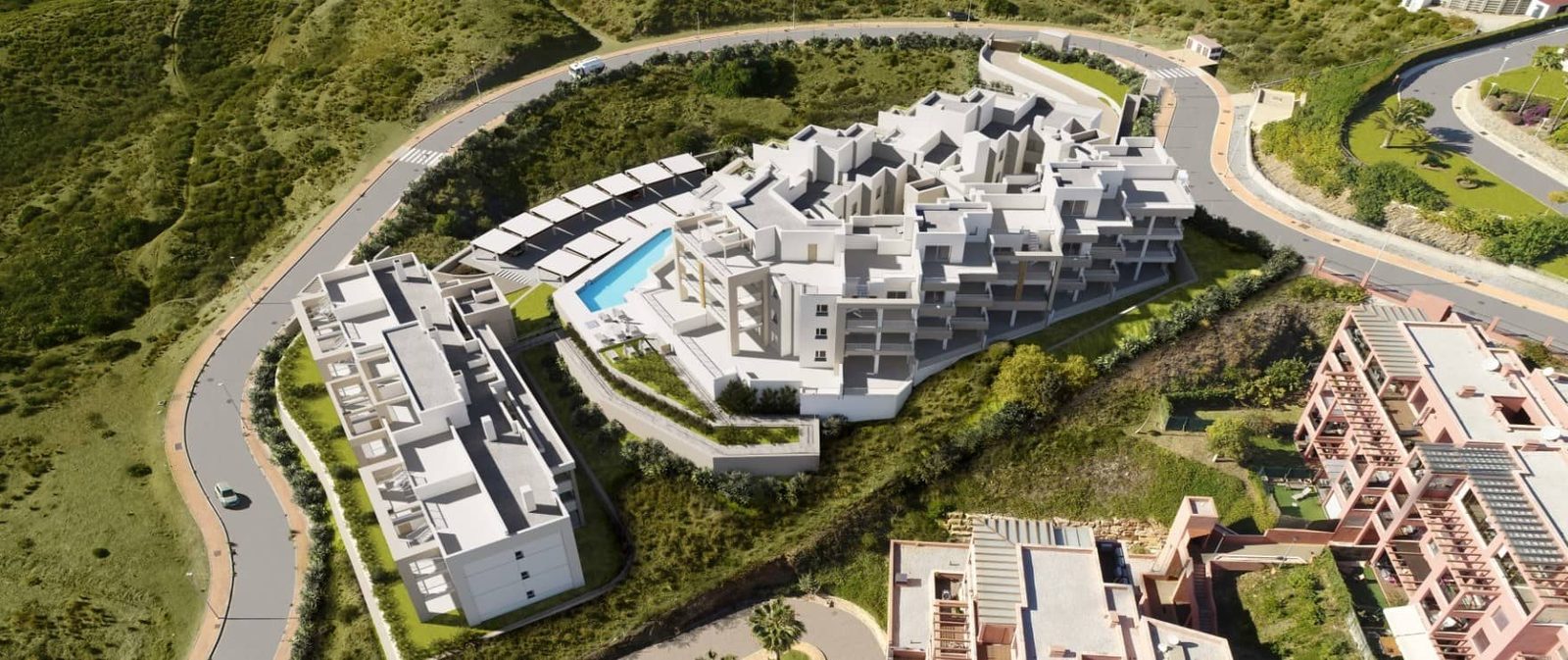 Aerial view of modern apartment complex with swimming pool and landscaped grounds in Las Lagunas de Mijas - The Estates