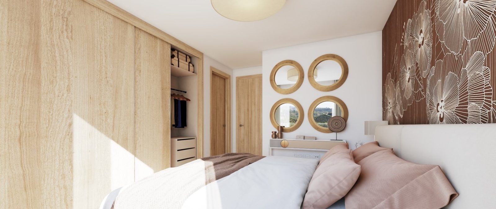 Bright bedroom with double bed, fitted wardrobes and round wall mirrors in a 2-bedroom apartment in Las Lagunas de Mijas - The Estates