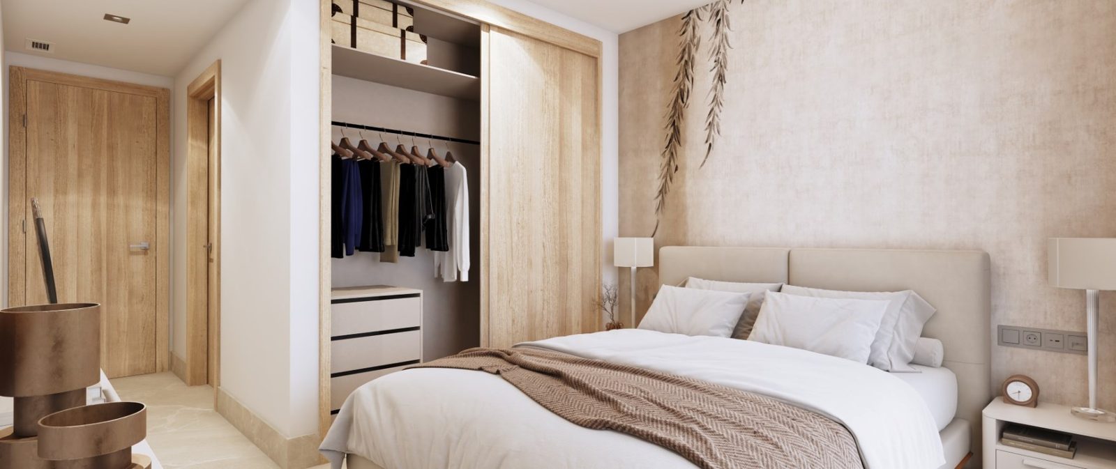 Master bedroom with upholstered bed, open wardrobe and bedside tables of a 2-bedroom apartment in Las Lagunas de Mijas - The Estates