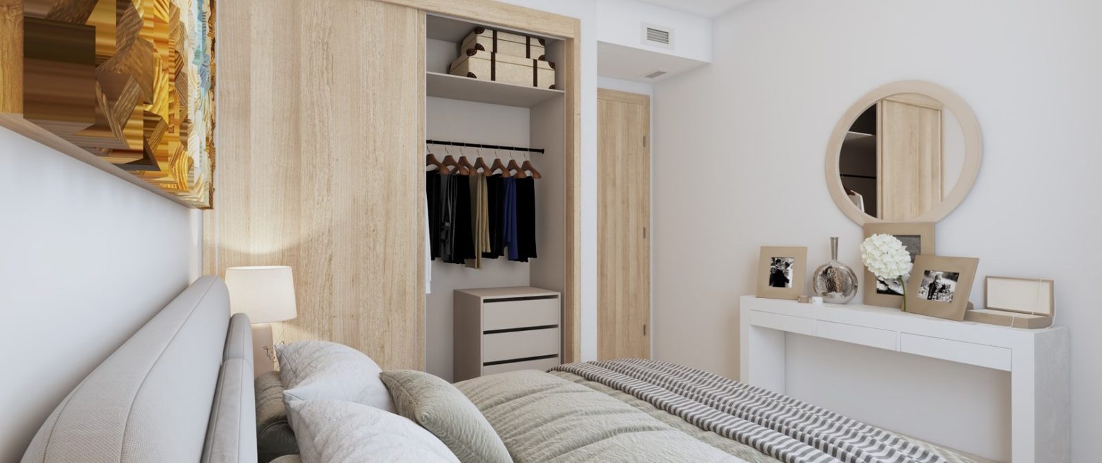Bright bedroom with open wardrobe, double bed, dressing table and round mirror in a 2-bedroom apartment in Las Lagunas de Mijas - The Estates