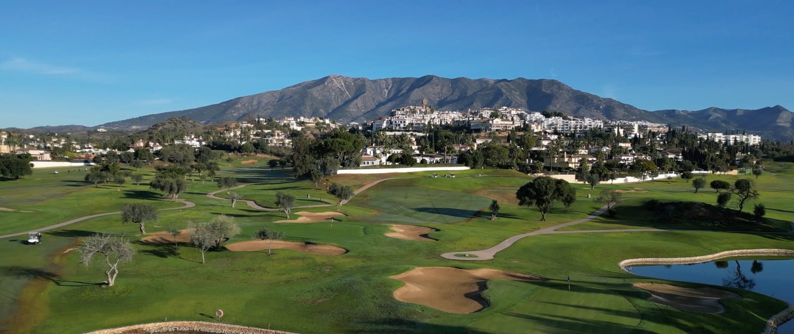 Panoramic golf course and mountain views from a 2-bedroom apartment in Las Lagunas de Mijas - The Estates