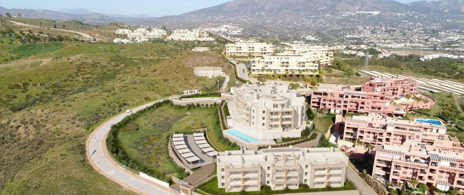 Aerial view of residential complexes and mountain landscape of a 2-bedroom apartment in Las Lagunas de Mijas - The Estates