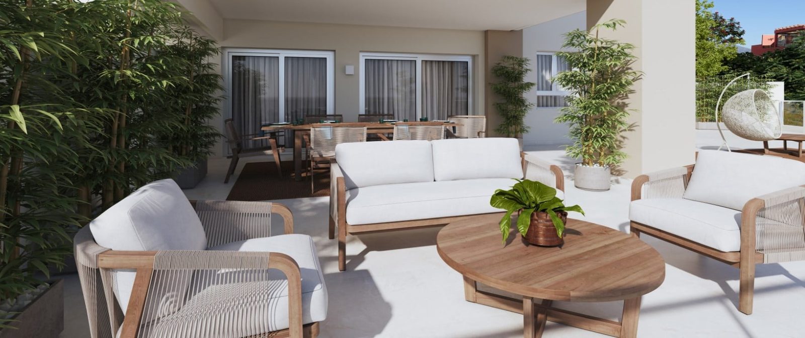 Outdoor terrace with lounge seating, dining table and potted plants at a 2-bedroom apartment in Las Lagunas de Mijas - The Estates