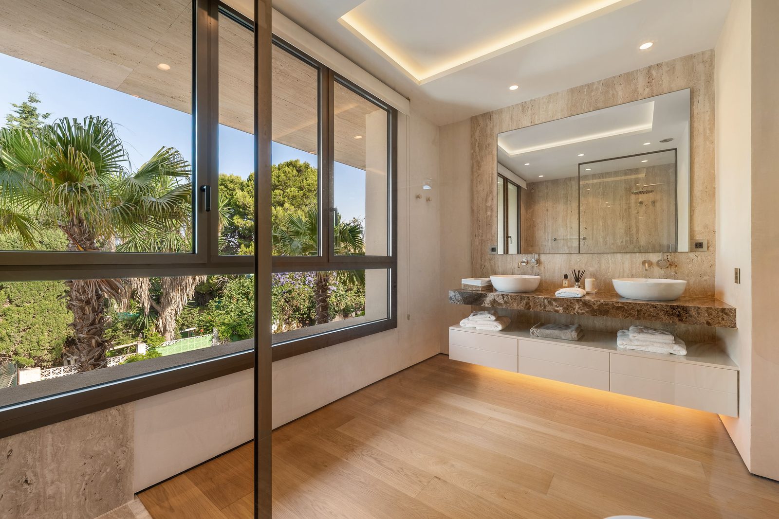 Modern bathroom with double vanity and garden views of a 4-bedroom penthouse in Málaga - The Estates