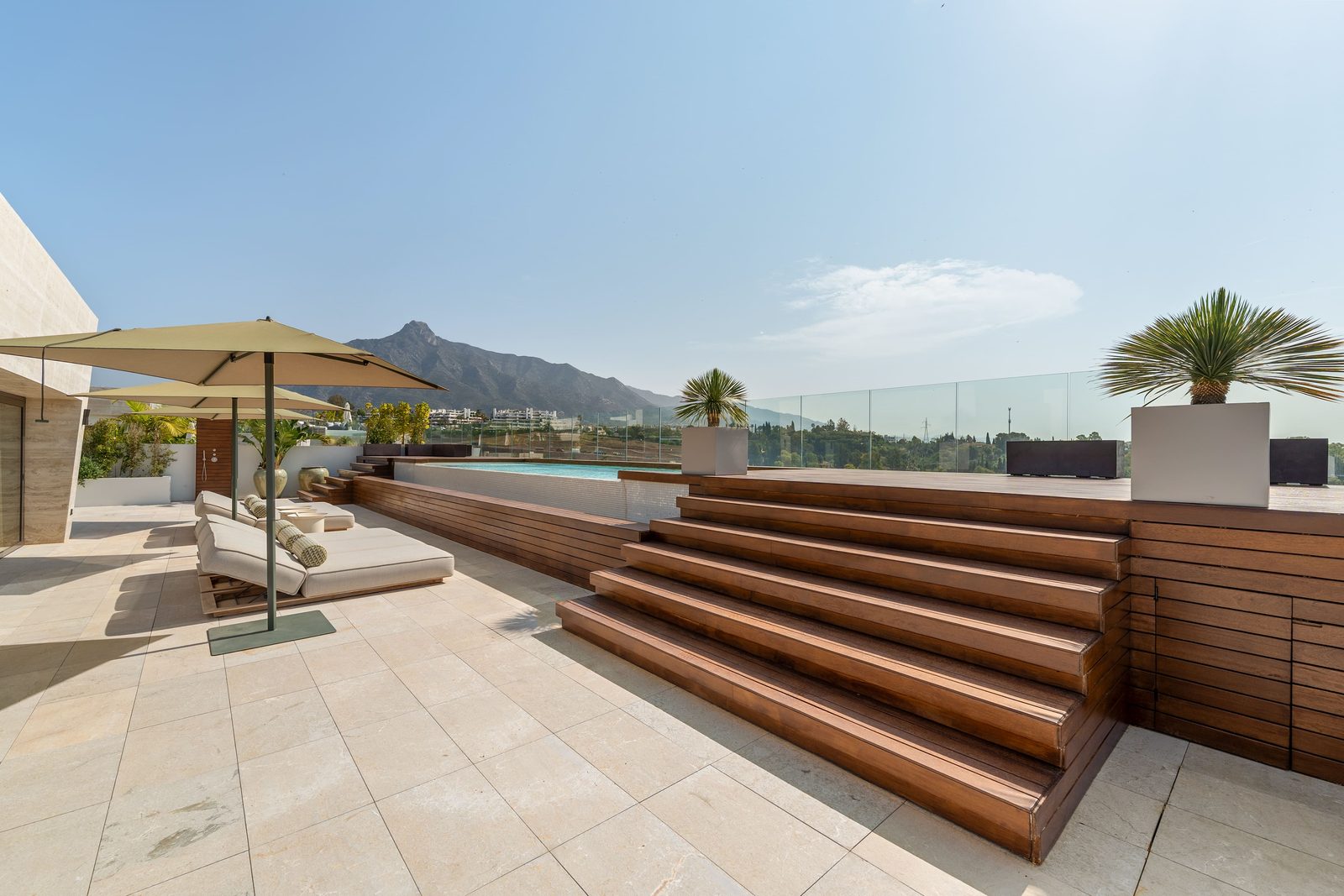 Rooftop terrace with pool, loungers and mountain views at a 4-bedroom penthouse in Málaga - The Estates