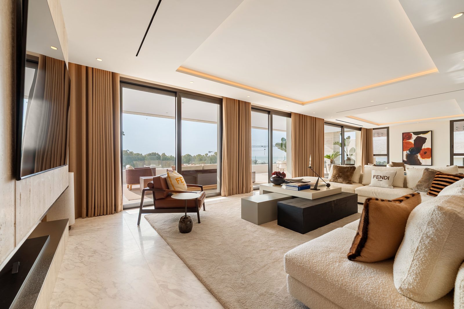 Elegant living room with floor-to-ceiling windows, sea views and designer furnishings in a 4-bedroom penthouse in Málaga - The Estates