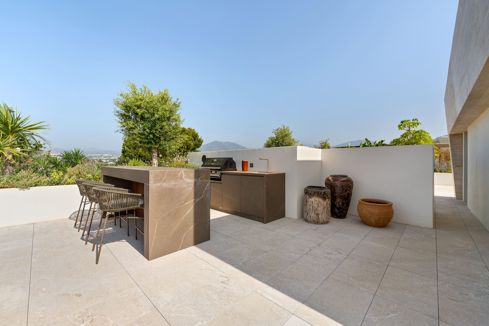 Outdoor kitchen and bar on a sunny terrace with