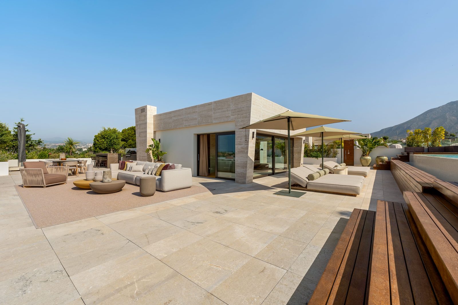 Rooftop terrace with pool, outdoor seating and sea and mountain views of a