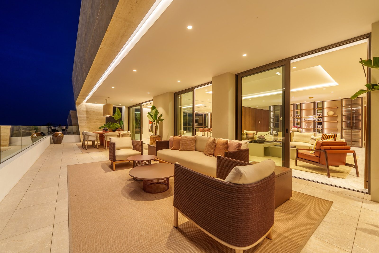 Furnished rooftop terrace with lounge and dining area at dusk in a 4-bedroom penthouse in Málaga - The Estates
