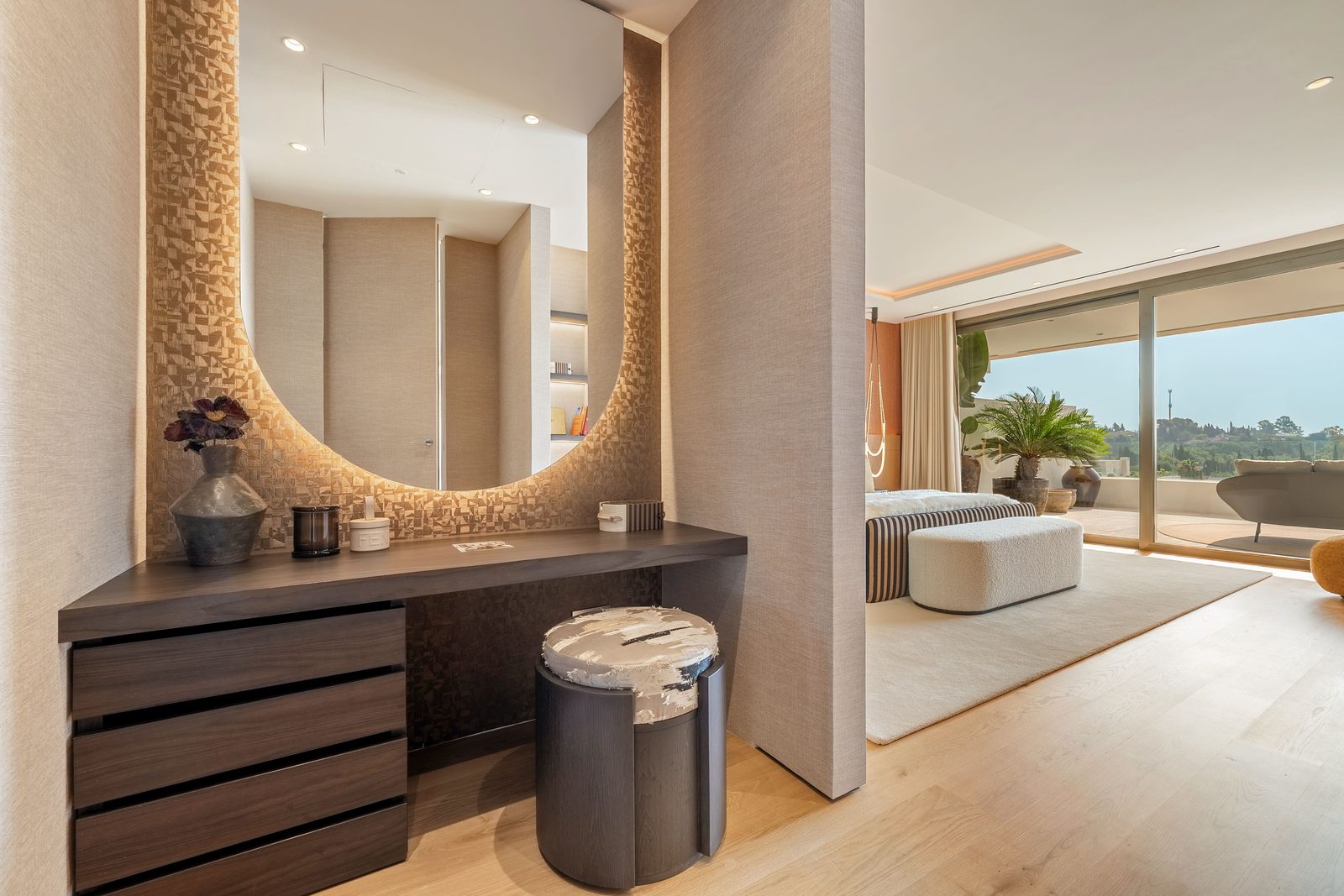 Elegant penthouse hallway with console and sculptural mirror opening to a bright living room and sea-view terrace in Marbella, Málaga - The Estates