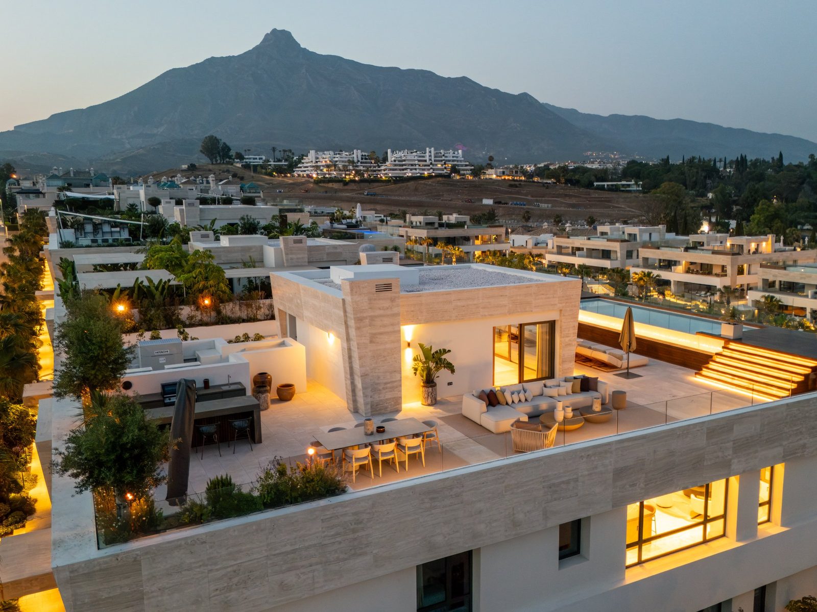 Rooftop terrace with outdoor lounge and dining area overlooking La Concha mountain in Marbella of a 4-bedroom penthouse in Málaga - The Estates