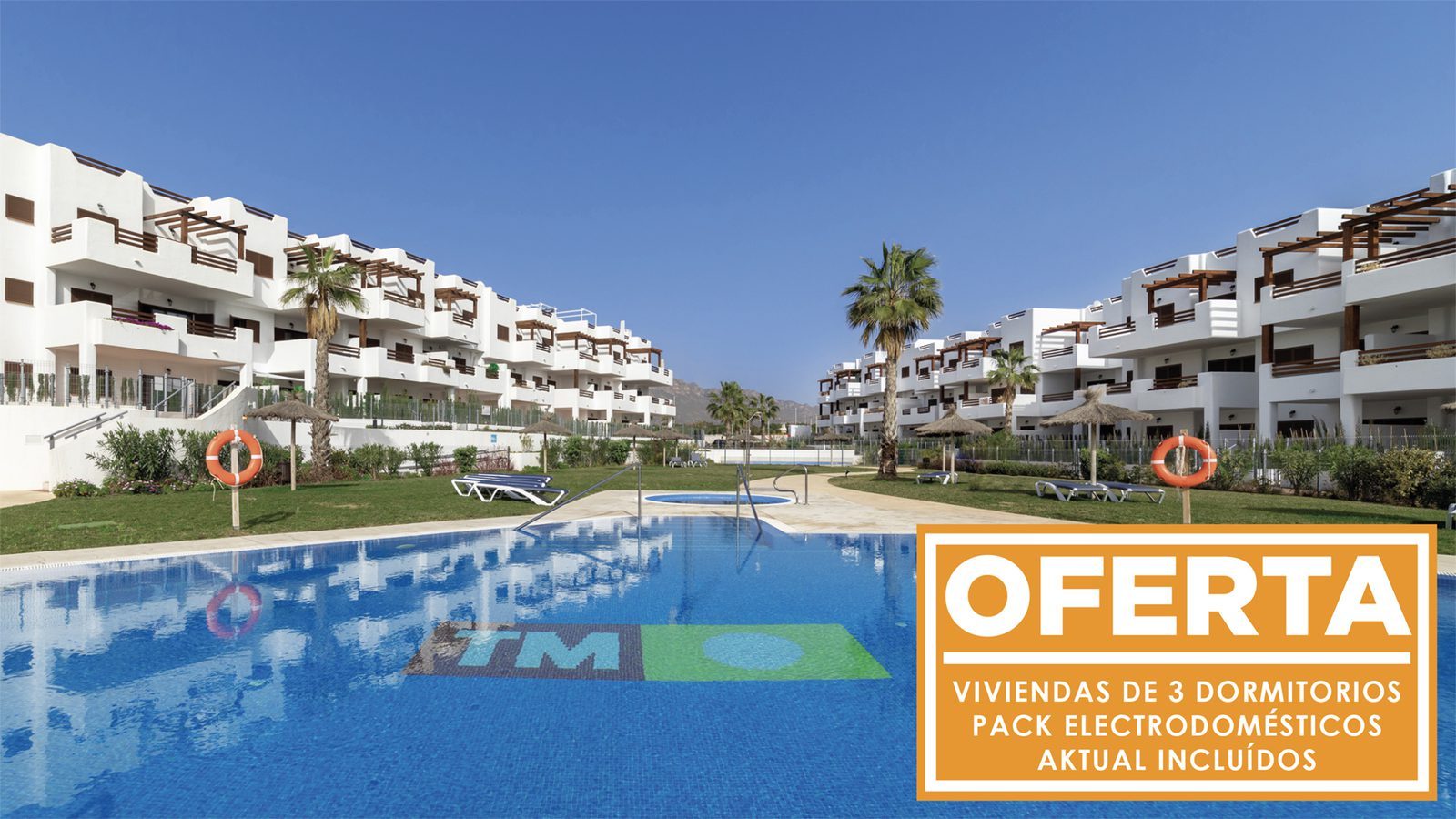Communal swimming pool and landscaped gardens surrounded by white bungalows in Pulpí - The Estates