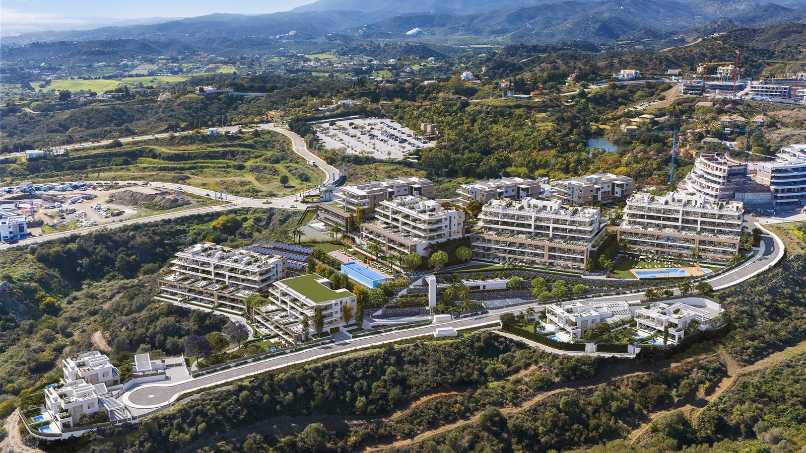 Aerial view of a modern residential development with countryside and mountain views, for a 3-bedroom apartment in