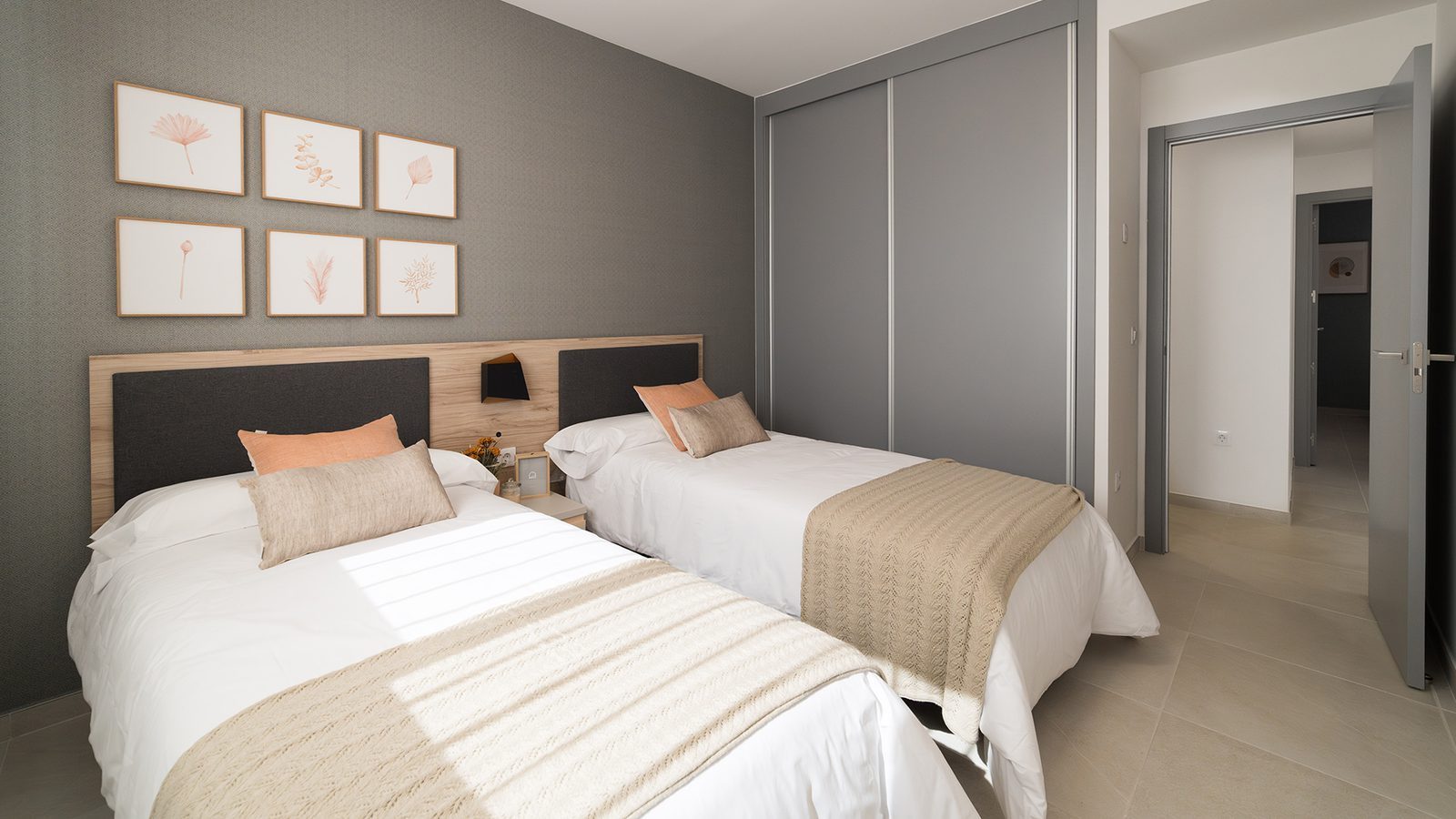 Twin bedroom with two beds, bedside tables and framed botanical artwork in a 2-bedroom bungalow in Pulpí - The Estates