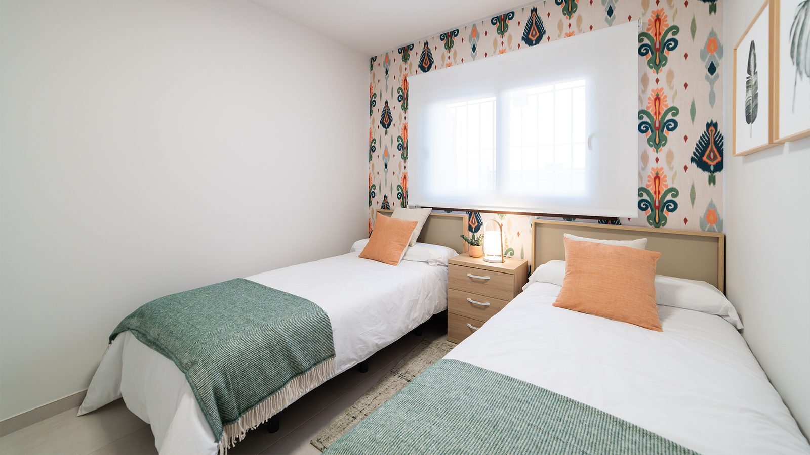 Twin bedroom with patterned feature wall, bedside table and window in a 2-bedroom bungalow in Pulpí - The Estates