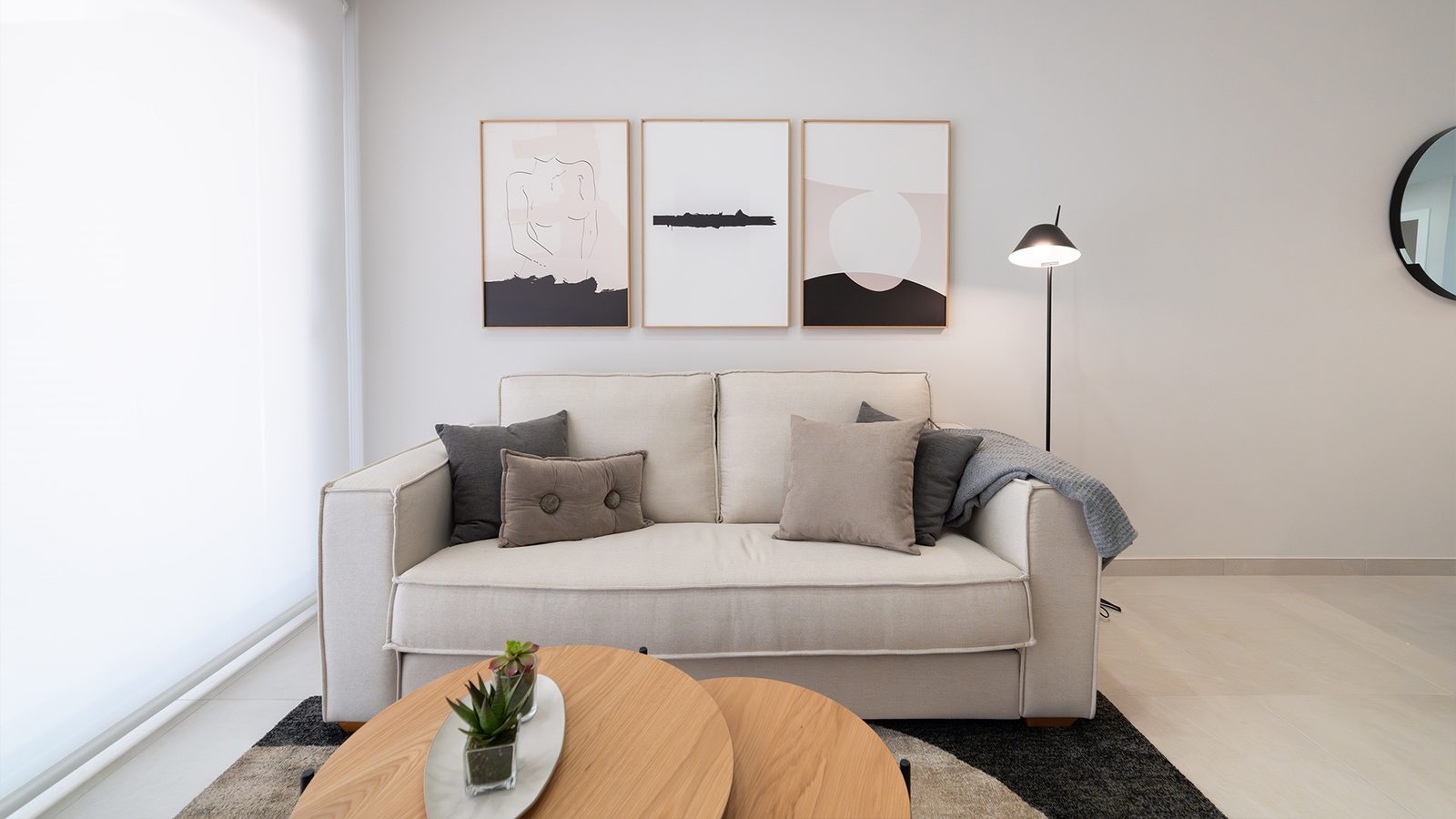 Contemporary living room with sofa, coffee tables and wall art in a 2-bedroom bungalow in Pulpí - The Estates