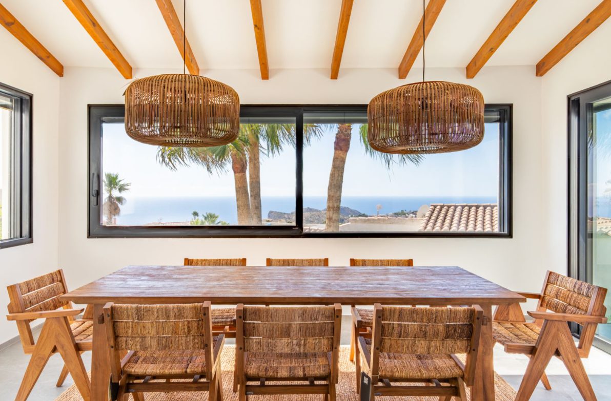 Stylish dining area with sea and mountain views inside a 5-bedroom villa in Benitachell - The Estates
