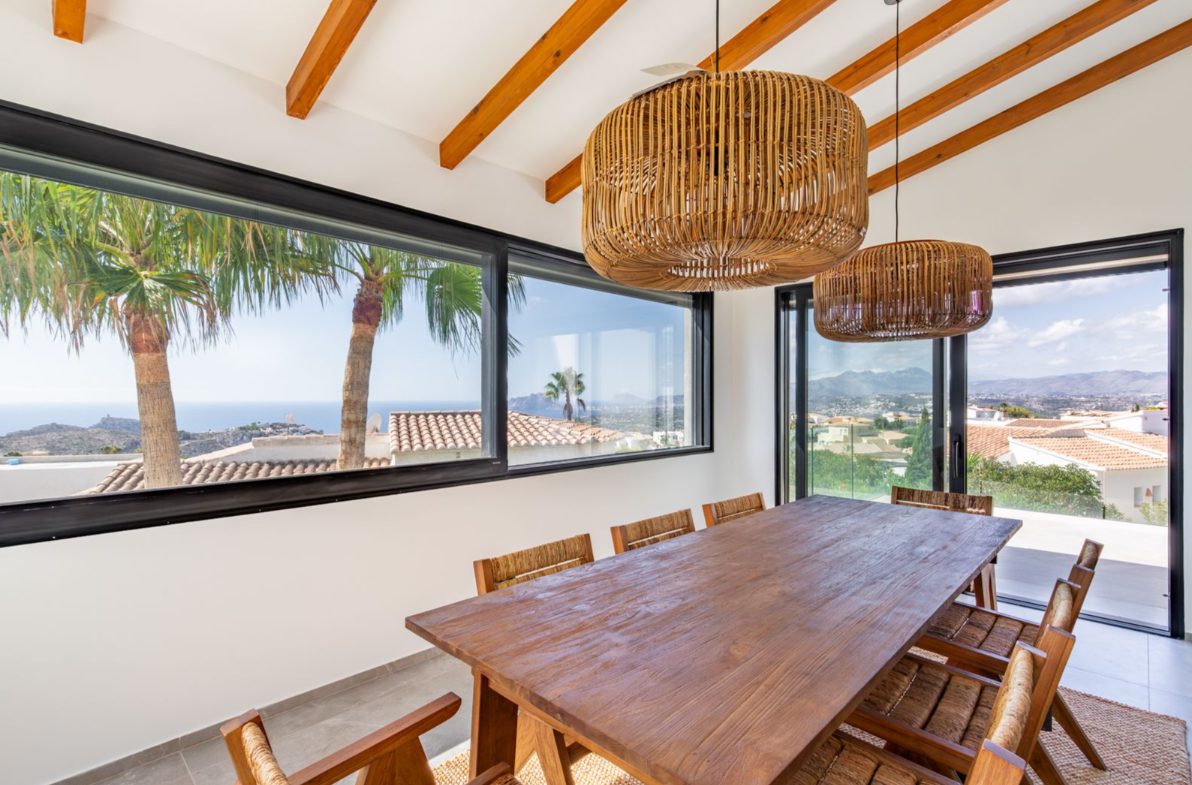 A bright dining area with stunning sea and mountain views in a 5-bedroom villa in Benitachell - The Estates
