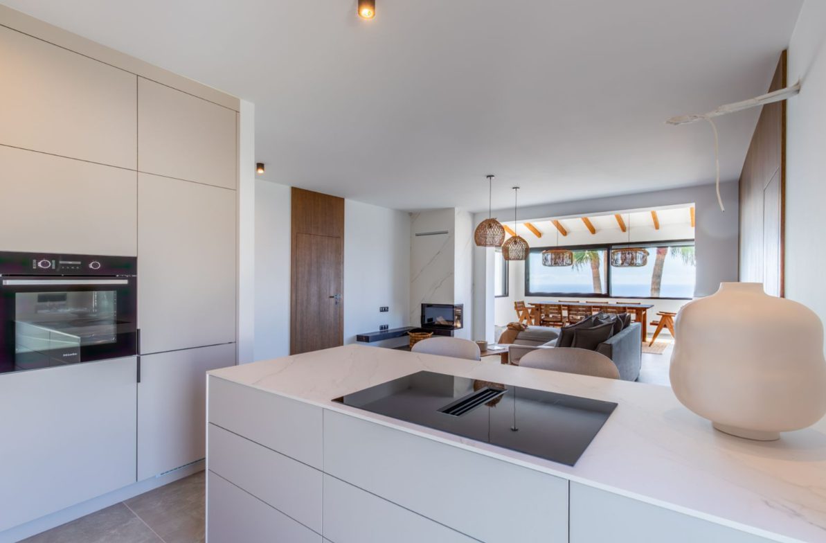Modern kitchen with island and sea views inside a 5-bedroom villa in Benitachell - The Estates