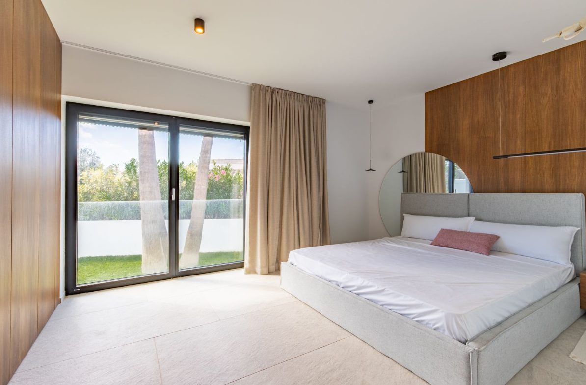 A bright bedroom with garden views of a 5-bedroom villa in Benitachell - The Estates