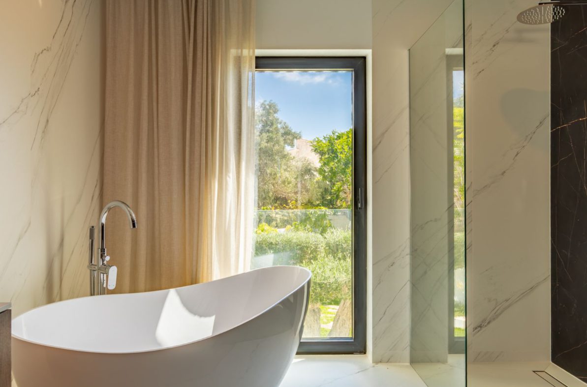 Luxurious bathroom with a freestanding tub and stunning views of a 5-bedroom villa in Benitachell - The Estates