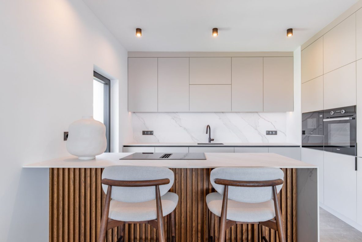 Modern kitchen with island seating in a 5-bedroom villa in Benitachell - The Estates
