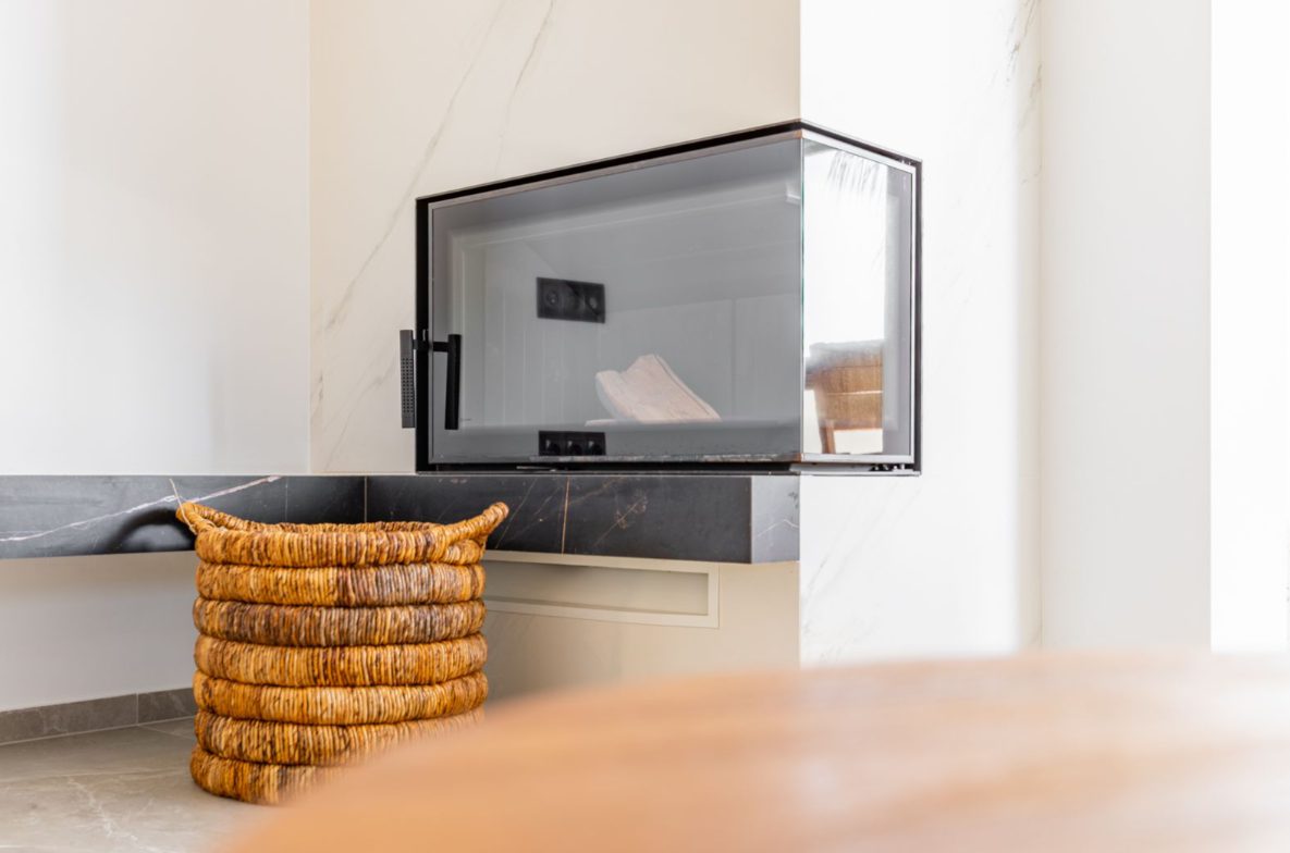 Stylish fireplace and wicker basket detail in a 5-bedroom villa in Benitachell - The Estates
