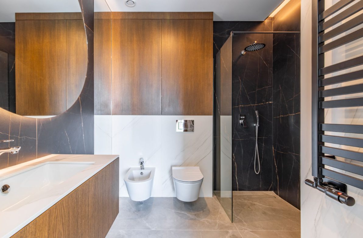 A modern bathroom with a walk-in shower and sleek fixtures in a 5-bedroom villa in Benitachell - The Estates