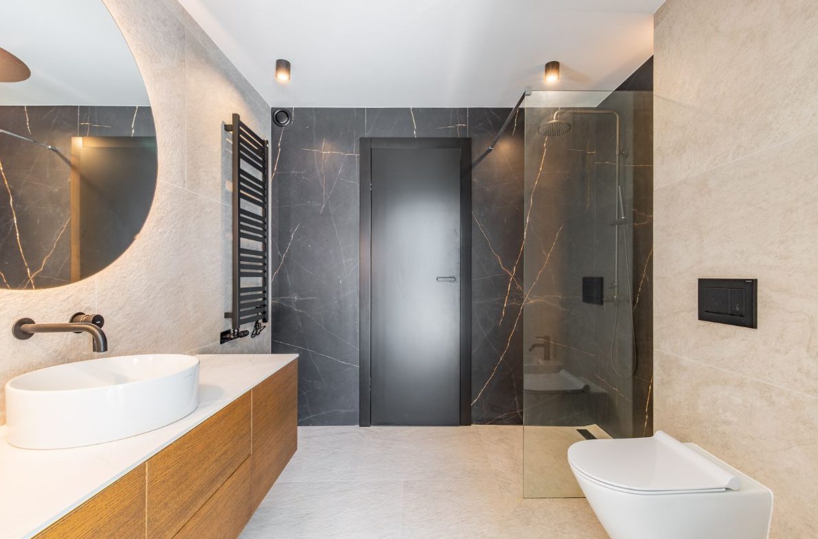 A modern bathroom with a walk-in shower and stylish fixtures in a 5-bedroom villa in Benitachell - The Estates