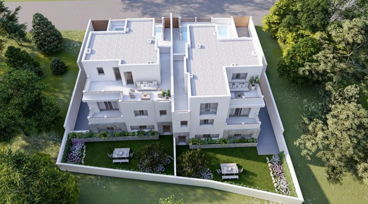 Aerial view of a modern white villa with rooftop terraces, balconies and landscaped gardens in Alfaz del Pi - The Estates