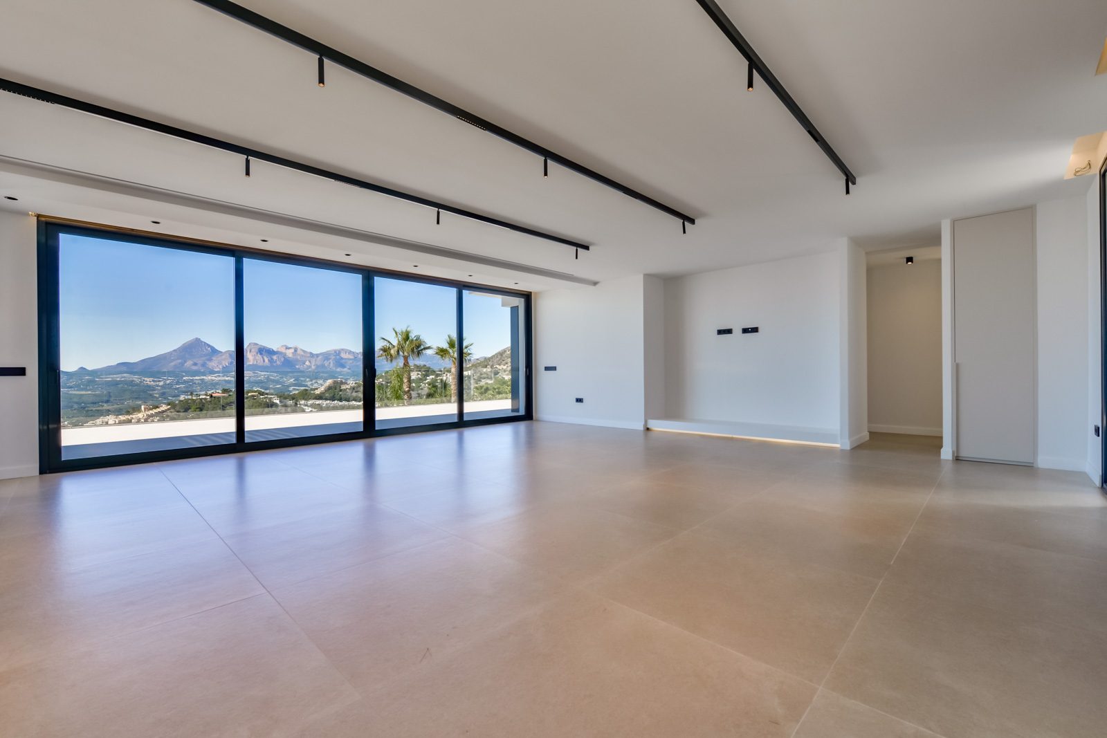 Bright open-plan living room with floor-to-ceiling windows and