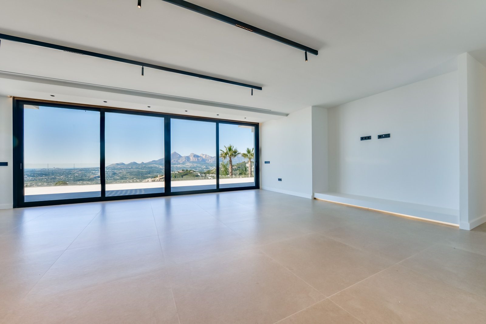 Modern living room with panoramic sea and mountain views of a 4-bedroom villa in Altea - The Estates