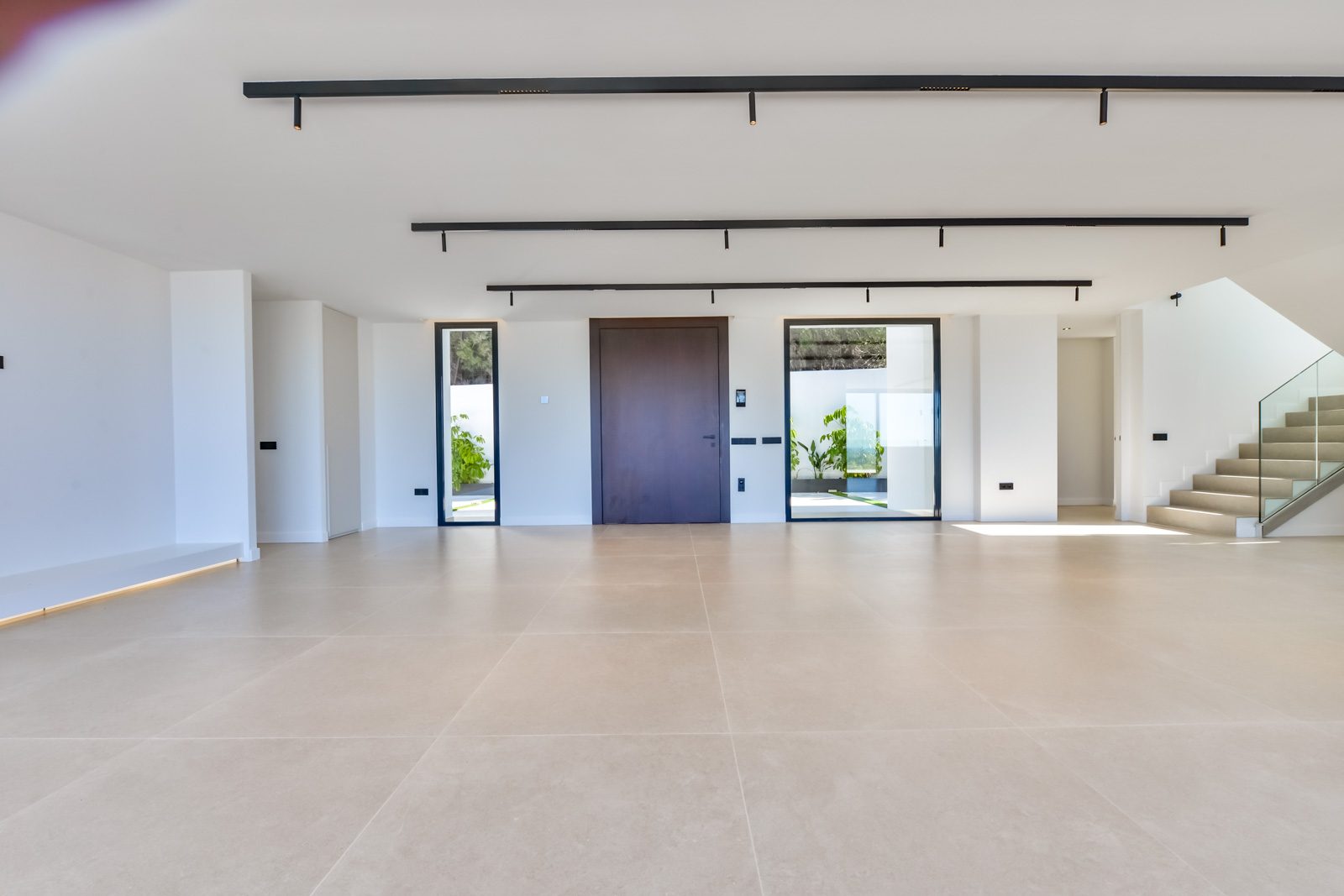 Modern entrance hall with staircase and glass doors of a 4-bedroom villa in