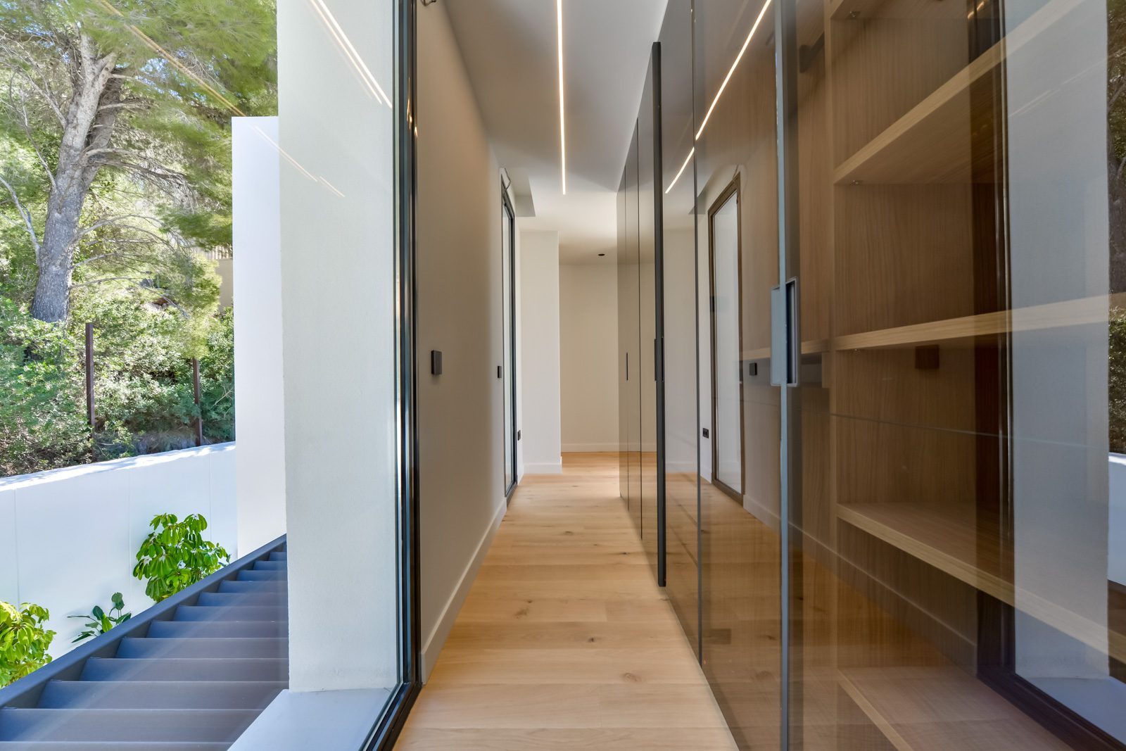 Modern hallway with built-in timber shelving and glass doors of a 4-bedroom villa in Altea - The Estates