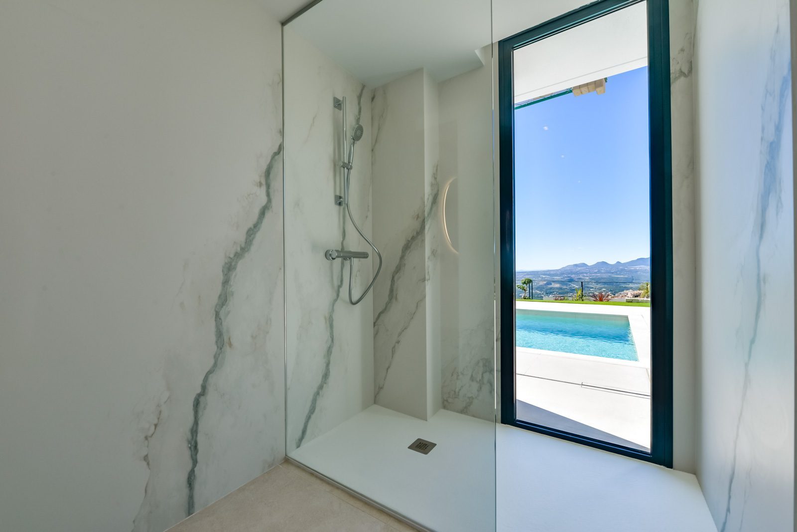 Marble walk-in shower with pool and mountain views in a 4-bedroom villa in Altea - The Estates