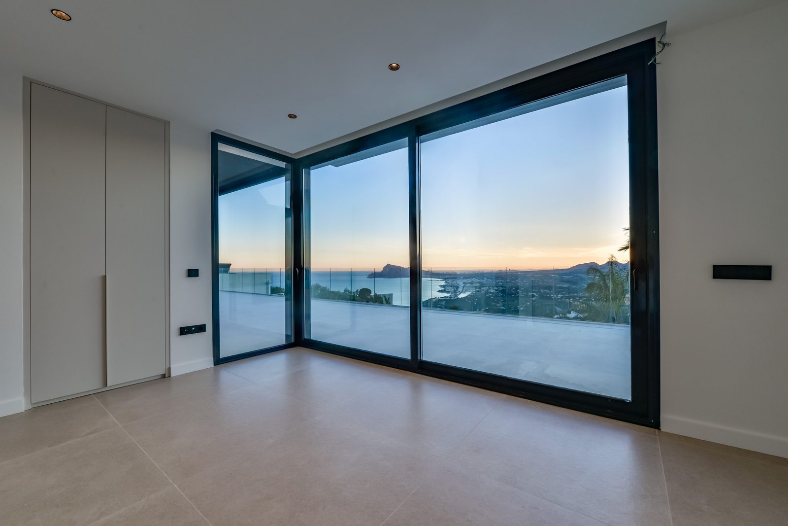 Modern interior with floor-to-ceiling windows and panoramic sea views of a 4-bedroom villa in Altea - The Estates