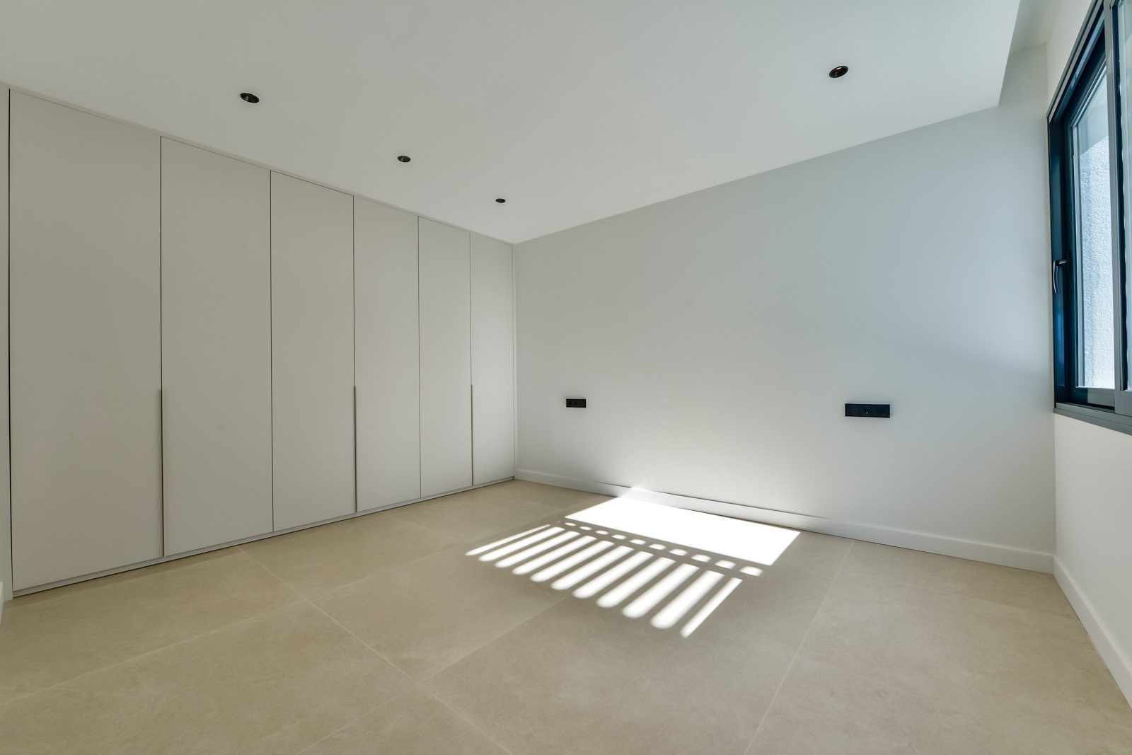 Bright modern bedroom with fitted wardrobes and large window in a 4-bedroom villa in Altea - The Estates