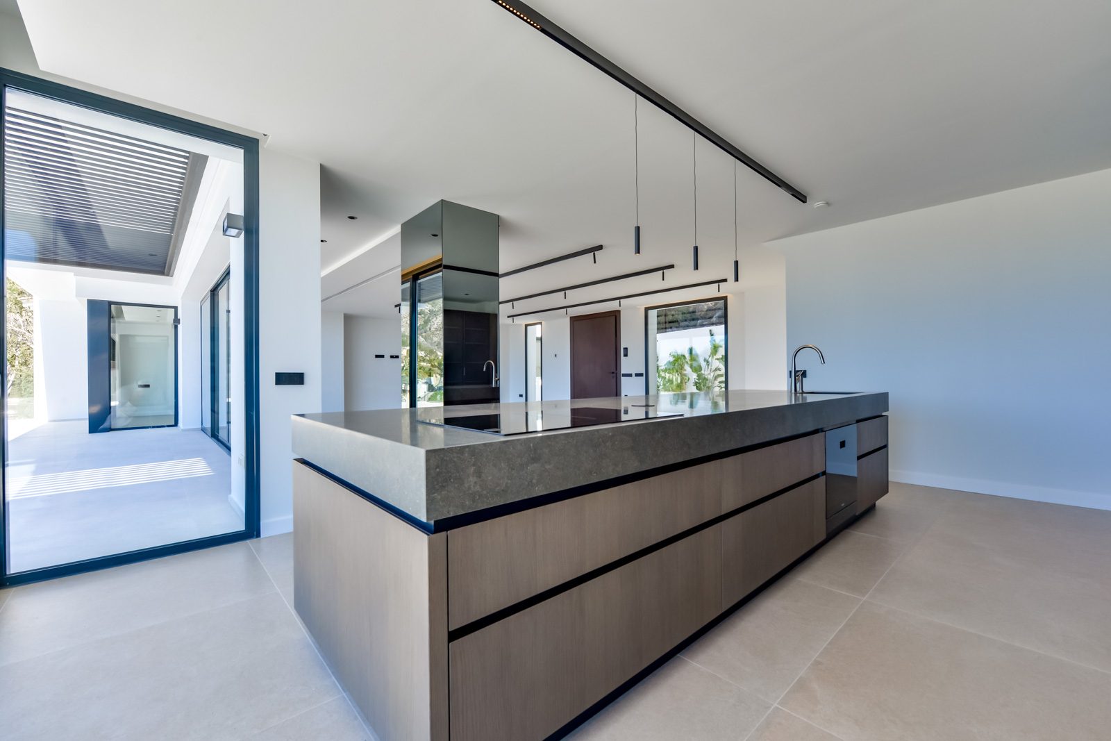 Modern open-plan kitchen with a large island in a 4-bedroom villa in Altea - The Estates