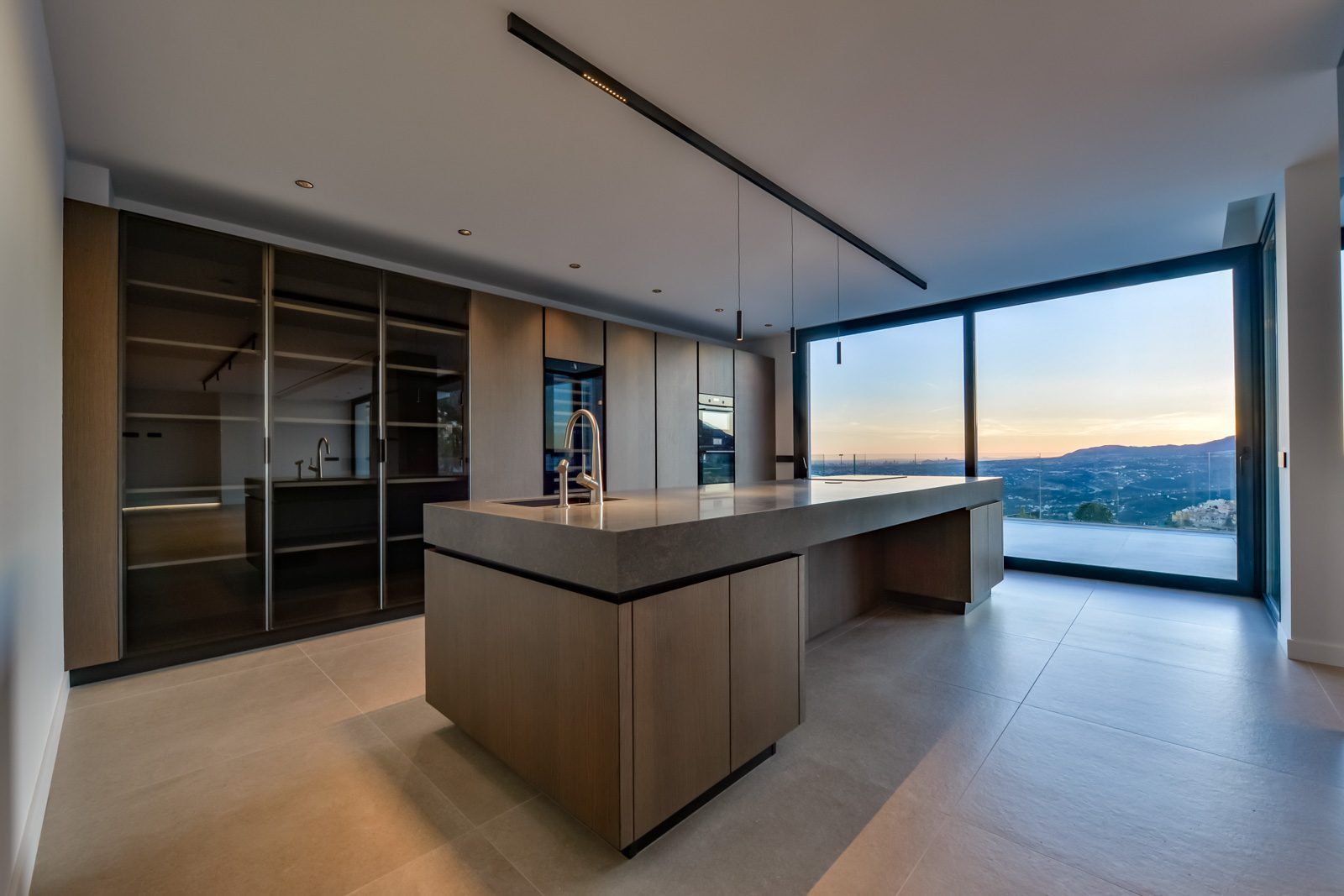 Modern kitchen with central island and panoramic sea views of a 4-bedroom villa in Altea - The Estates