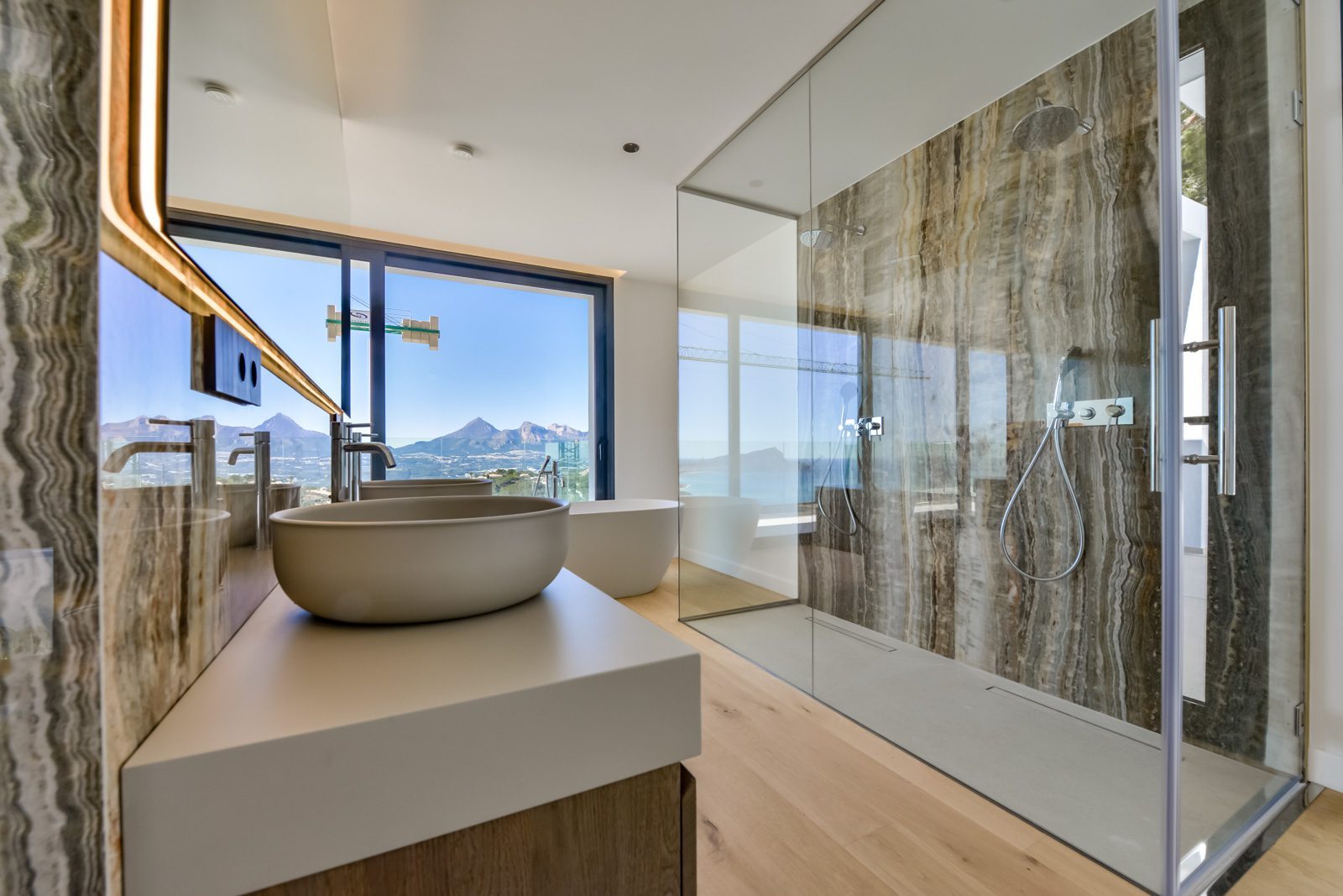 Modern bathroom with freestanding basin, walk-in shower and panoramic mountain and sea views in a 4-bedroom villa in Altea - The Estates