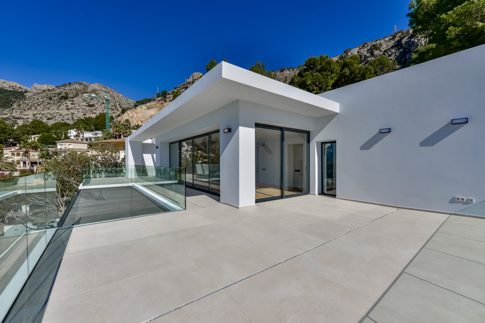 Modern villa terrace with glass railings and mountain views in Altea Hills - The Estates