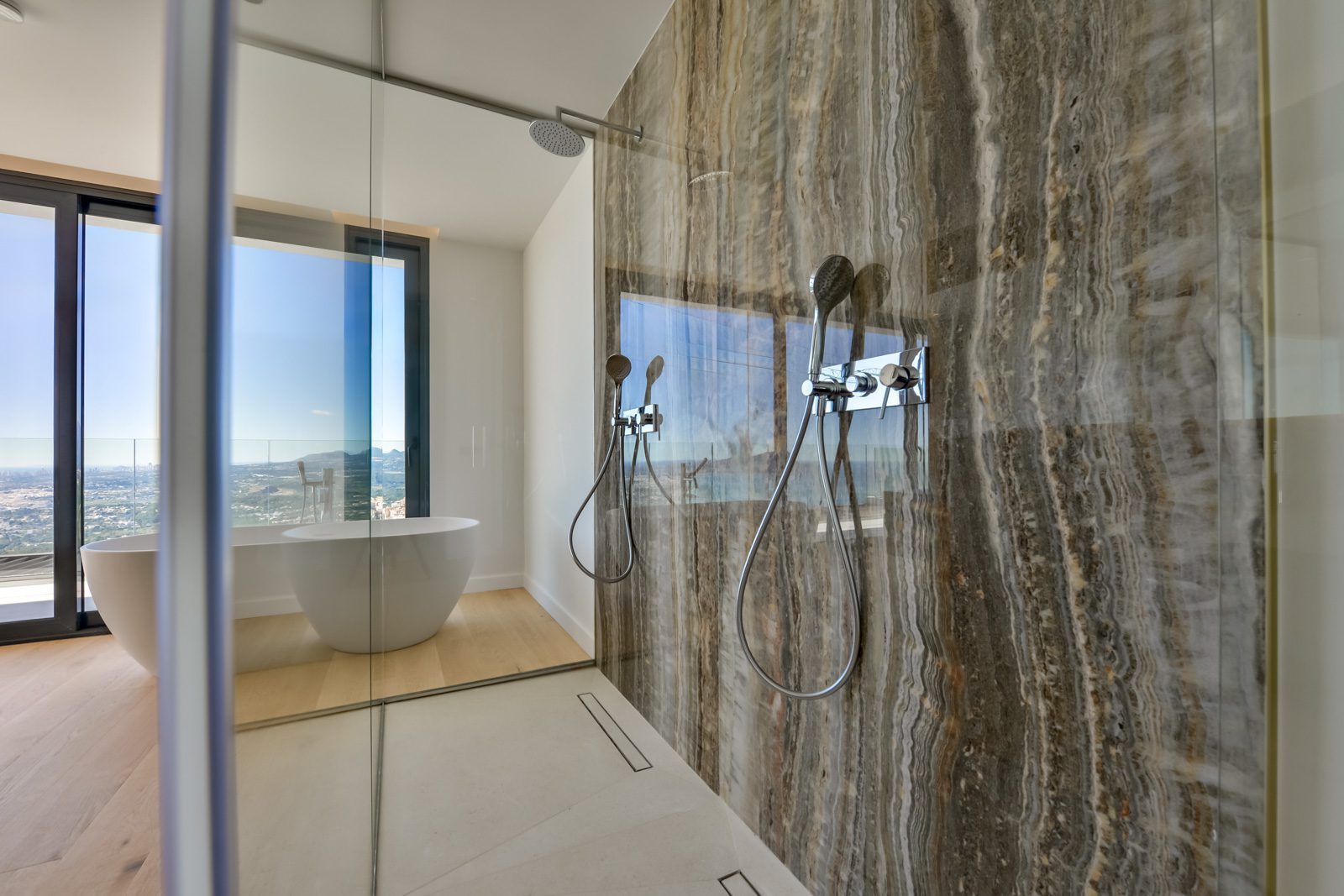 Marble walk-in shower and freestanding bathtub with panoramic sea views in a 4-bedroom villa in Altea - The Estates
