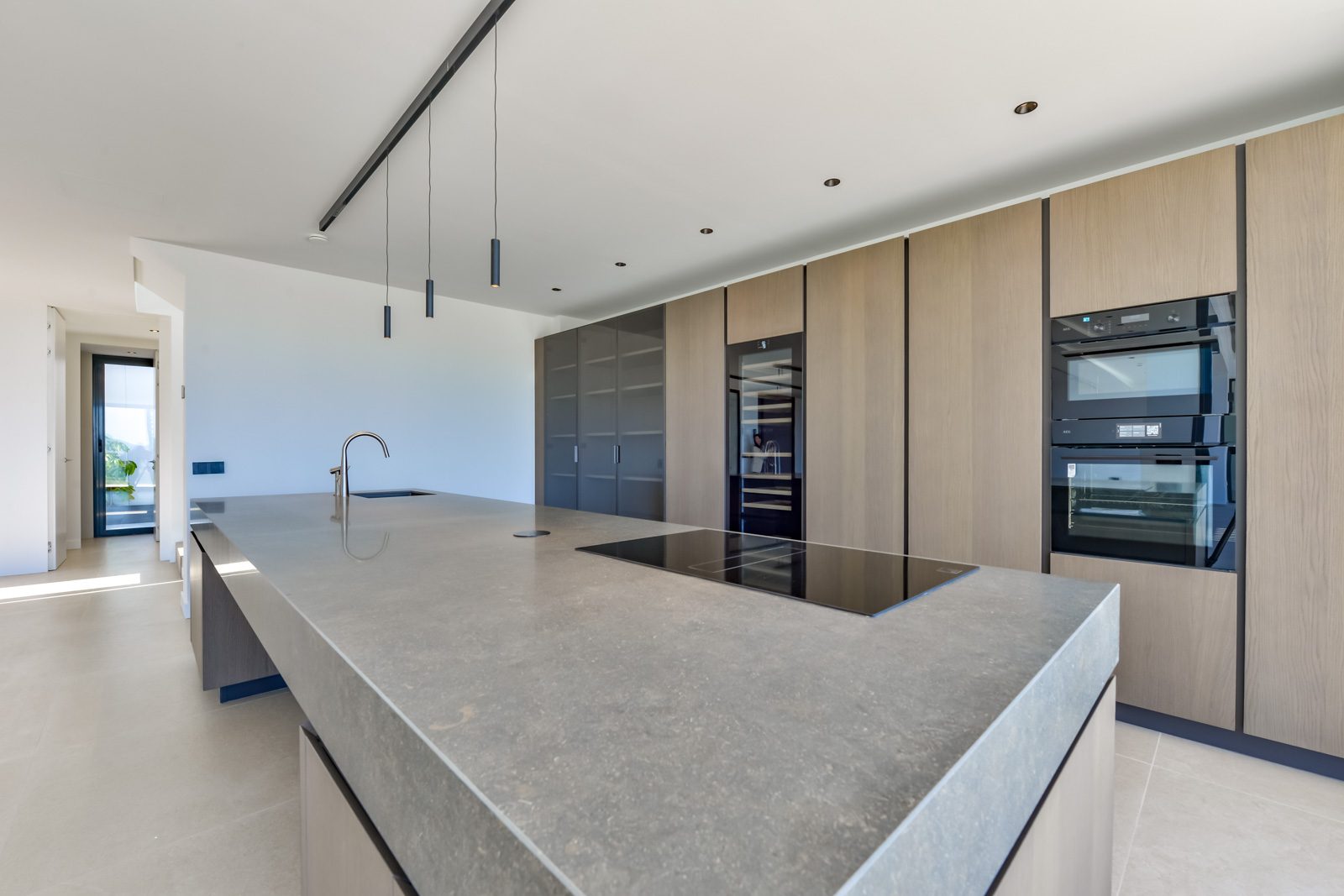Modern kitchen with large island and integrated appliances in a 4-bedroom villa in Altea - The Estates