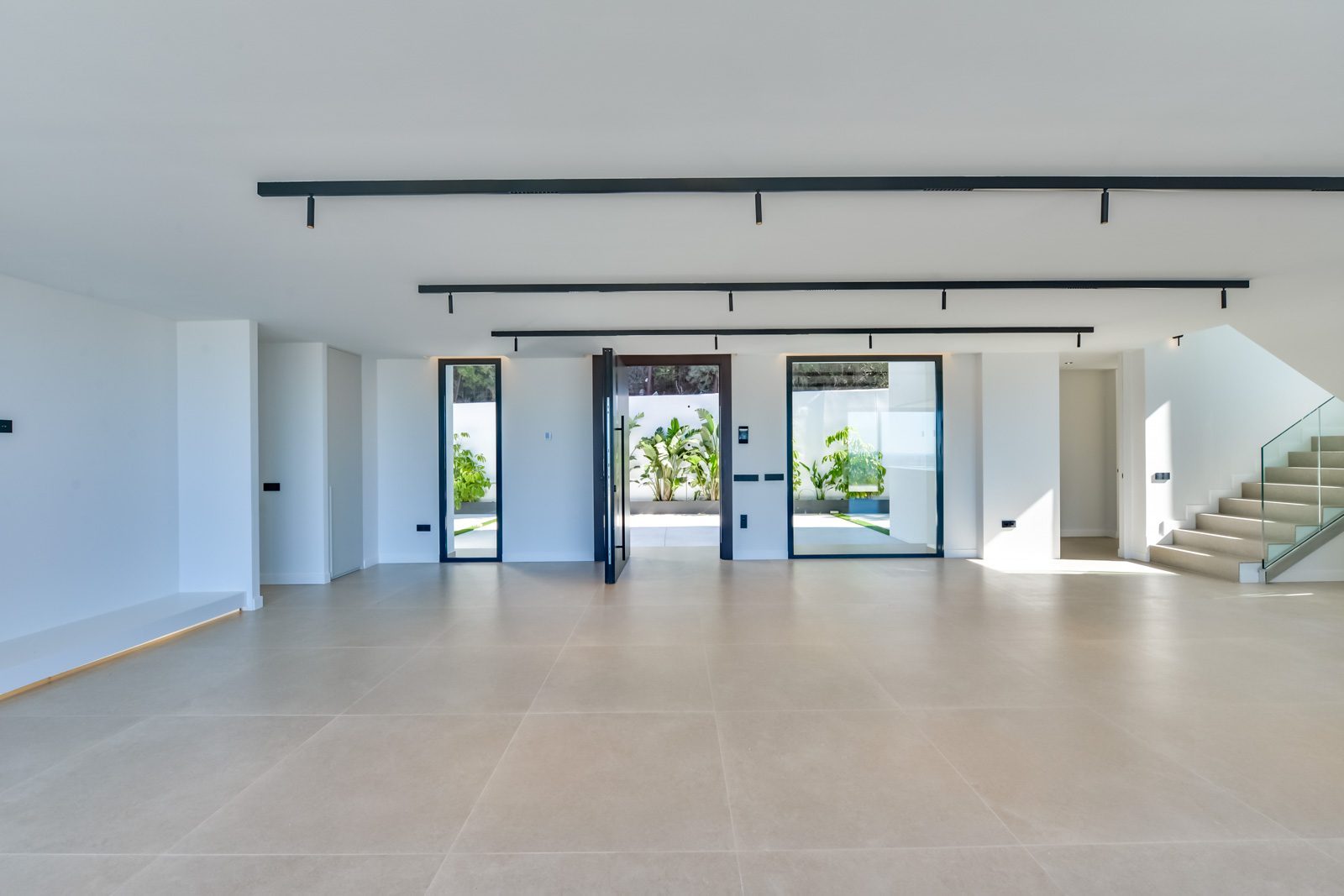 Bright modern living room with courtyard views and staircase in a 4-bedroom villa in Altea - The Estates