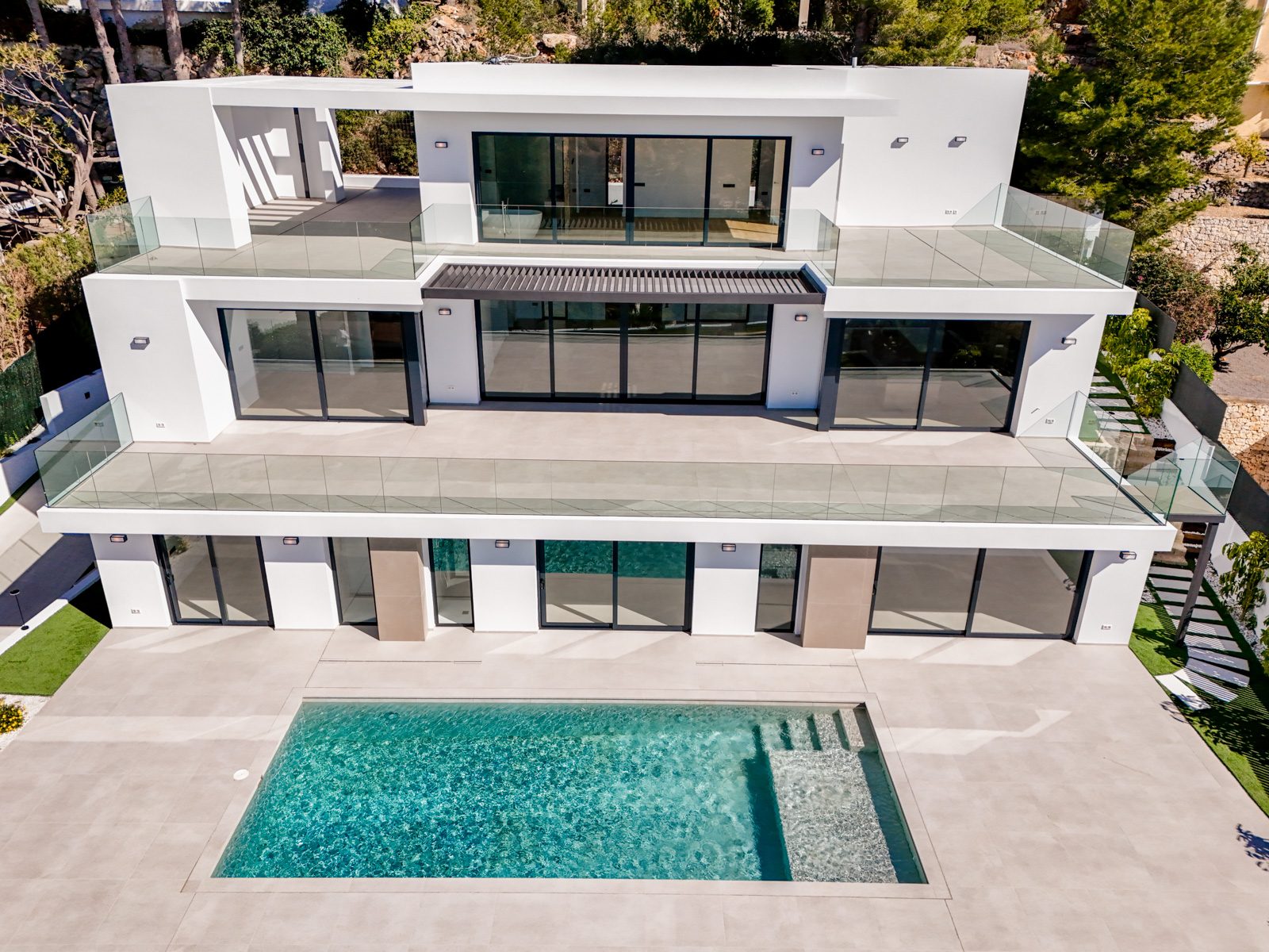 Modern white villa with glass terraces and