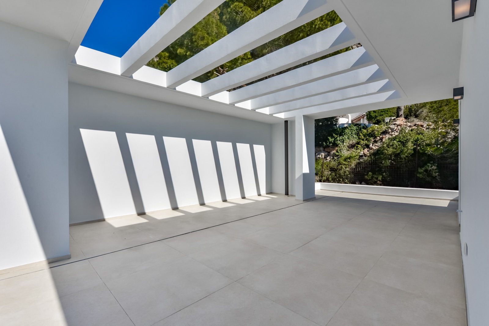 Covered terrace with white pergola and mountain views at a 4-bedroom villa in Altea - The Estates