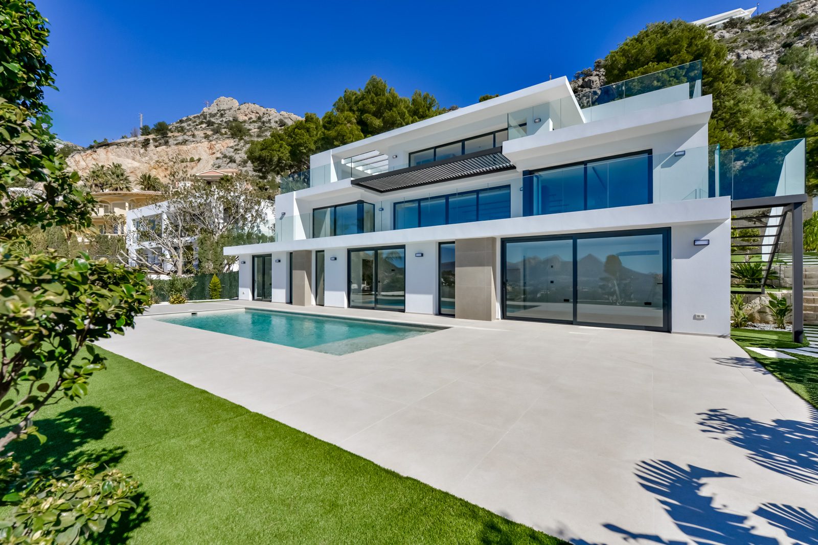 Modern villa exterior with pool and terraces of a